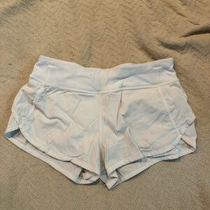 white ivivva athletic shorts with zipper pocket slight pilling on the back